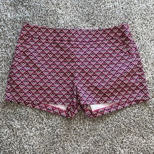 Bright pink & black geometric shaped Express shorts w/ pockets. Zips down side.